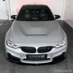 Performance Priekinio bamperio Pažeminimas skirtas BMW F80 / F82 / F83, juodas blizgus - V2 SUTVIRTINTA VERSIJA